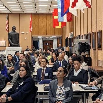 Participants in San Juan, Puerto Rico, watch a live broadcast of the panel discussion in Washington, D.C.