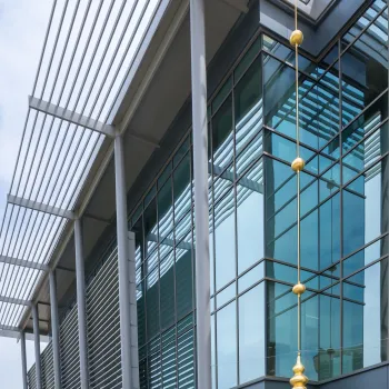This hanging sculpture on the outside of the new courthouse is made of gilded bronze.